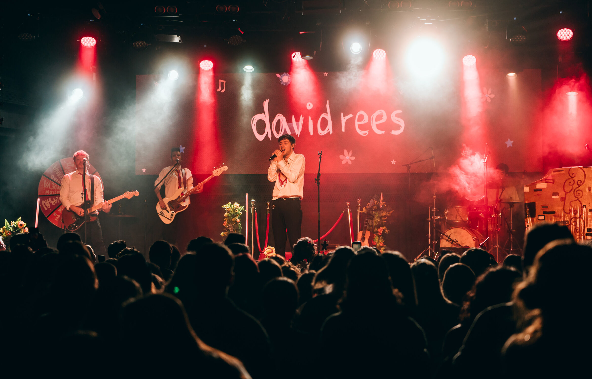 David Rees cantando en directo con su banda ante el público